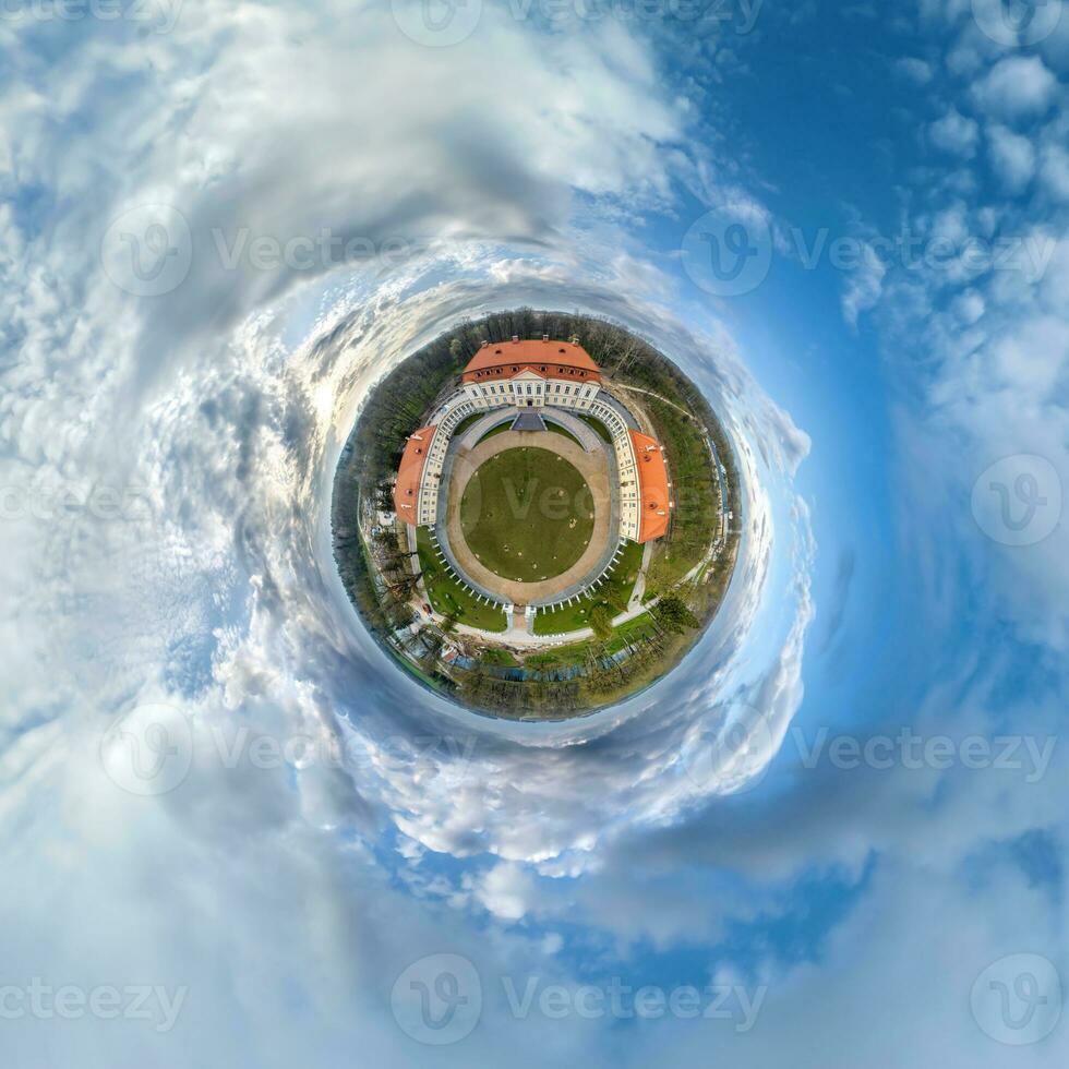 little planet and spherical aerial 360 panorama view on street ancient medieval castle with church and historic buildings with columns photo