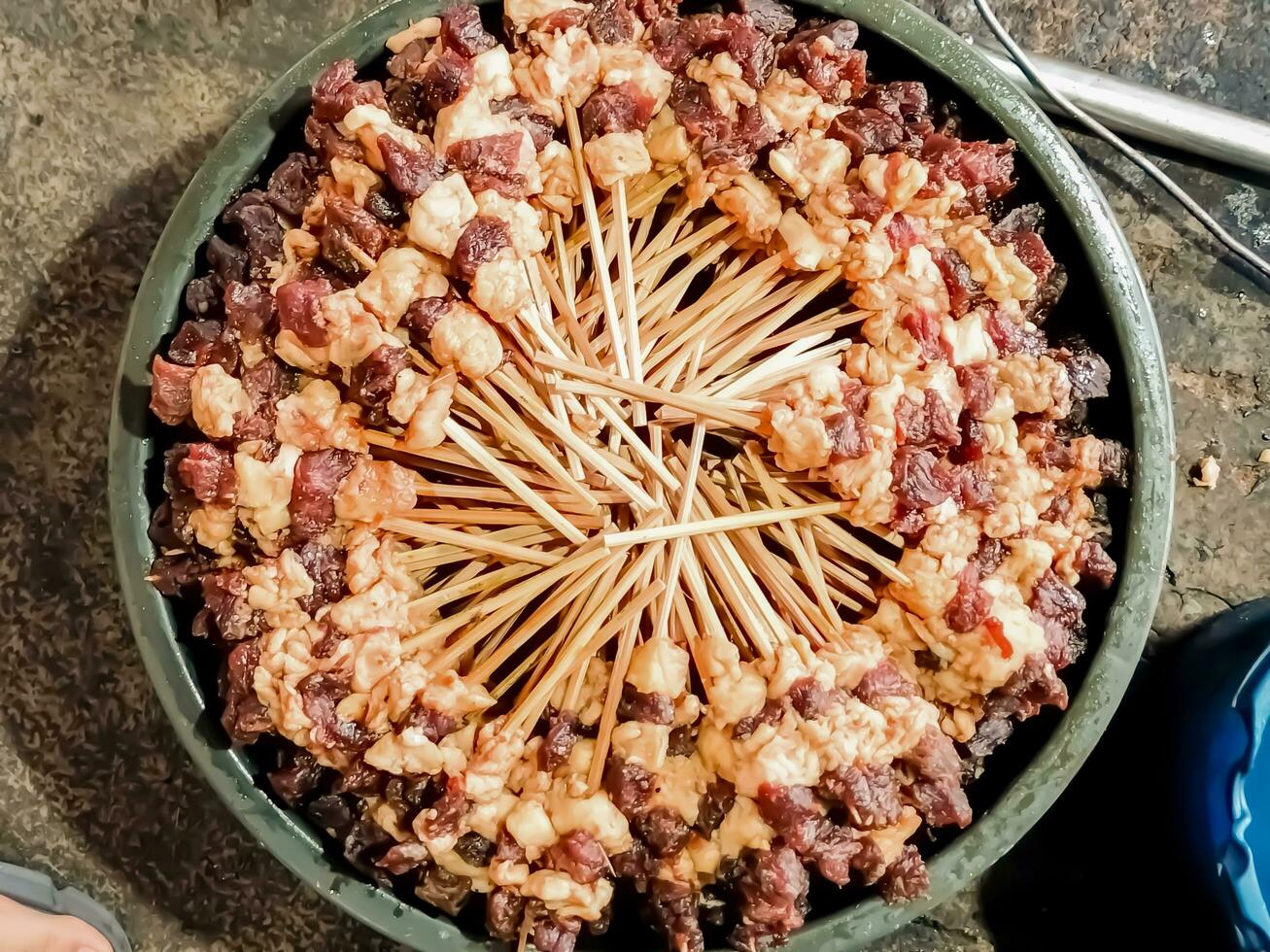 Background of Indonesian food raw beef satay stored neatly in a bucket ready to be grilled photo