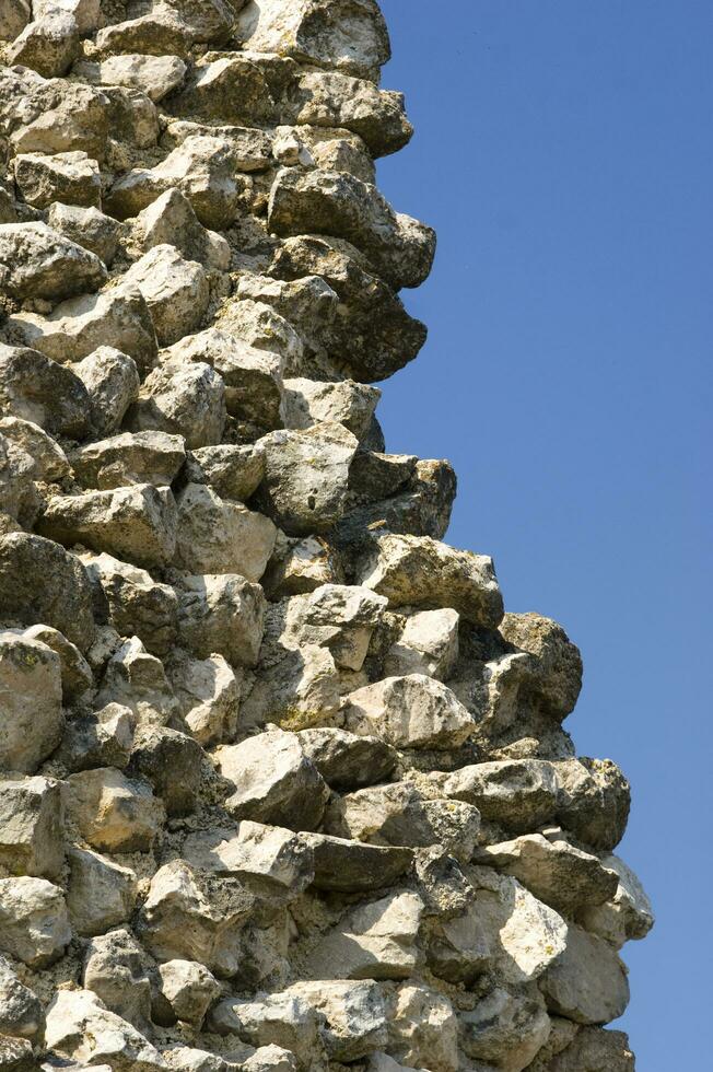 a stone wall with a large bird on it photo