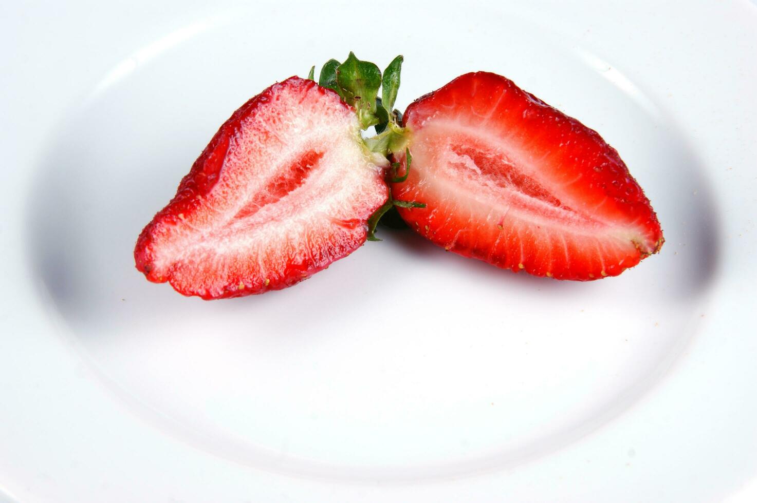 a glass bowl filled with strawberries photo