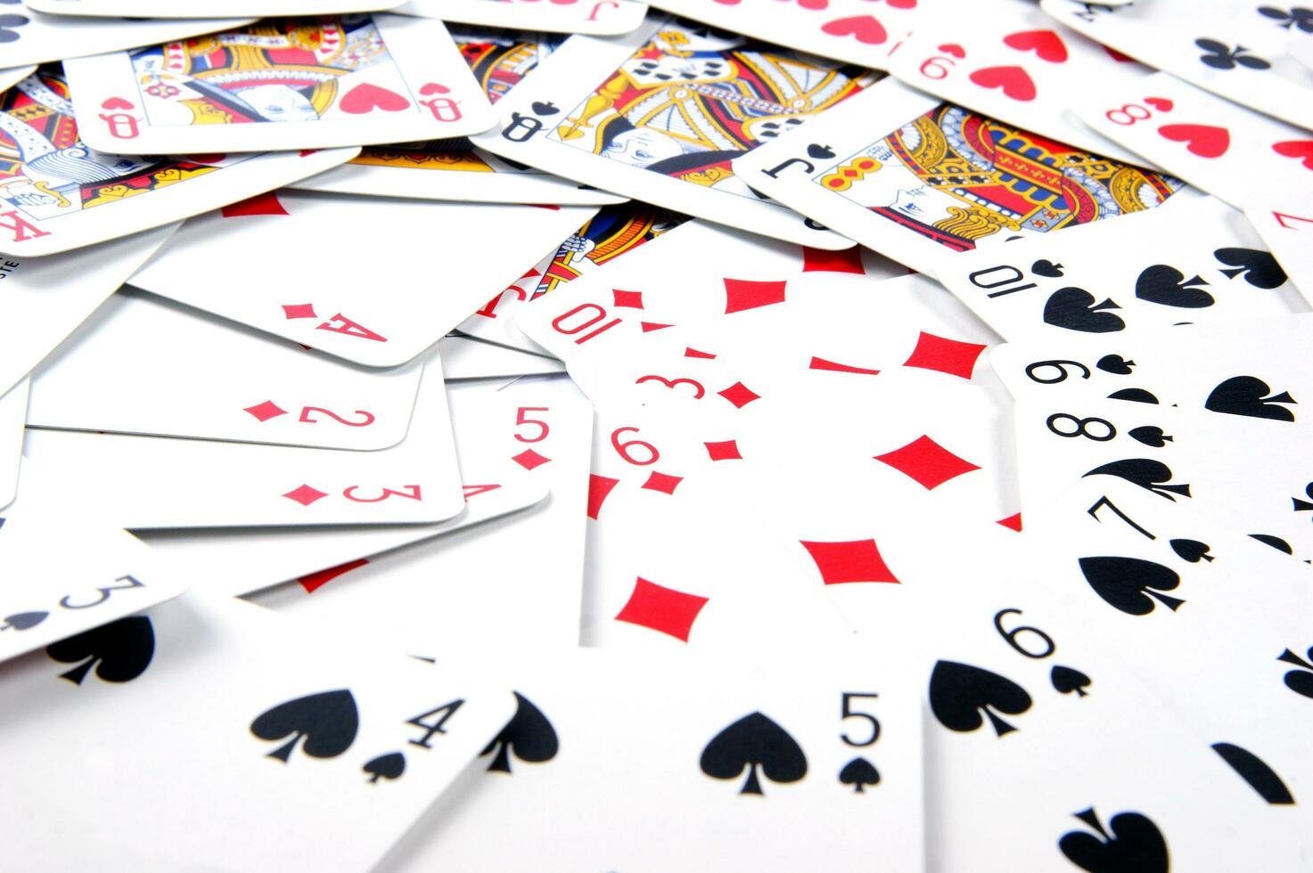 a pile of playing cards on a table photo