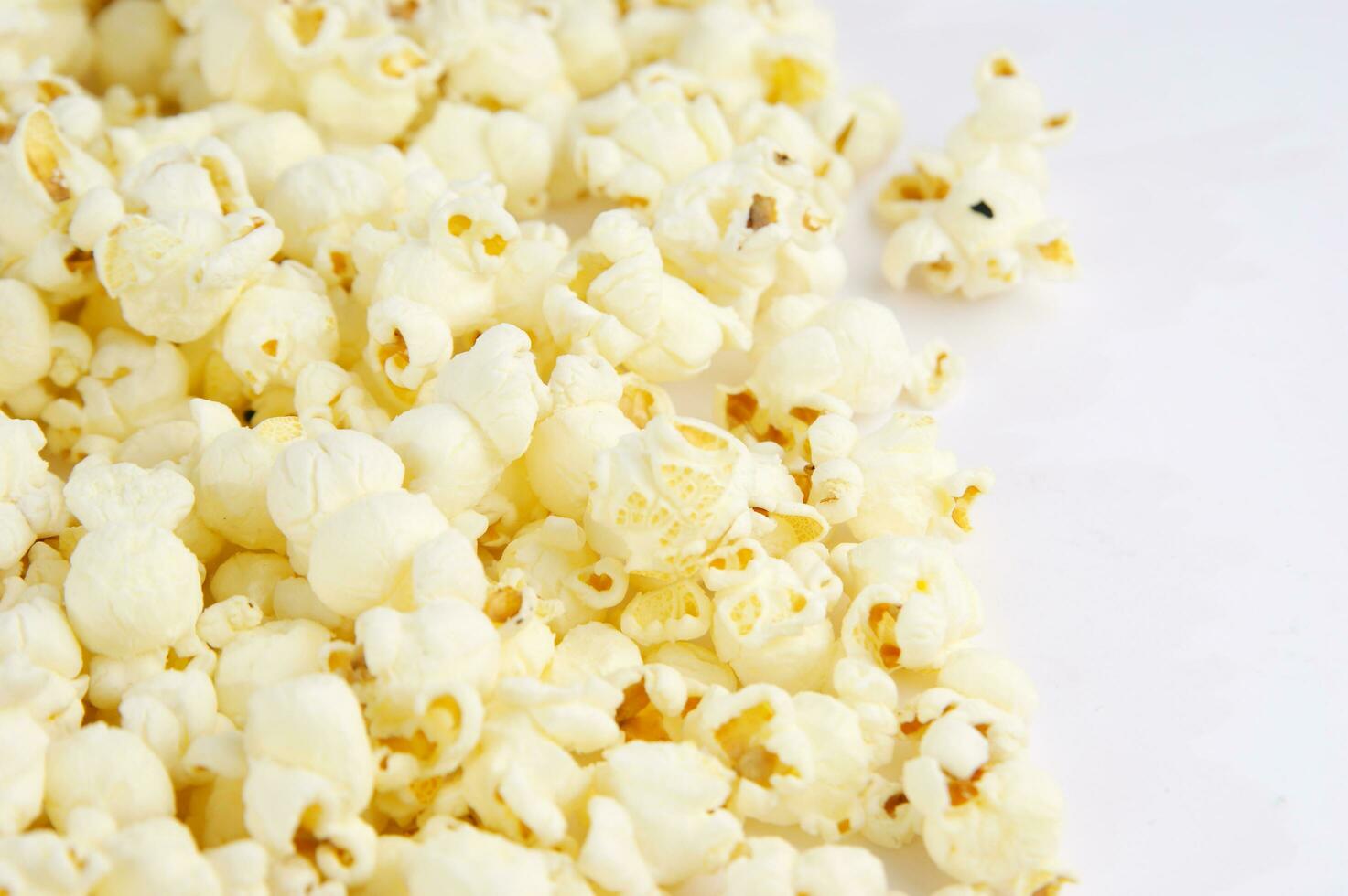 four colorful bowls of popcorn on a white surface photo