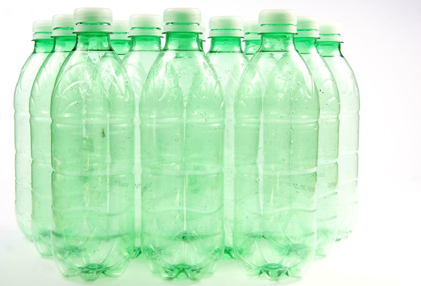 plastic bottles are scattered on a white surface photo
