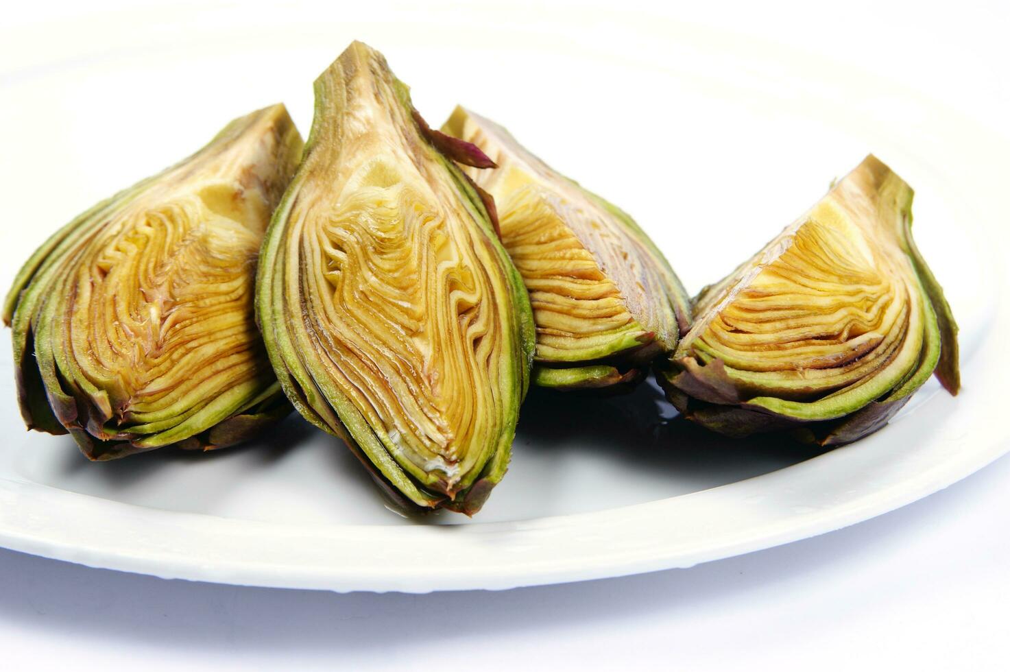 a white plate with four artichokes on it photo