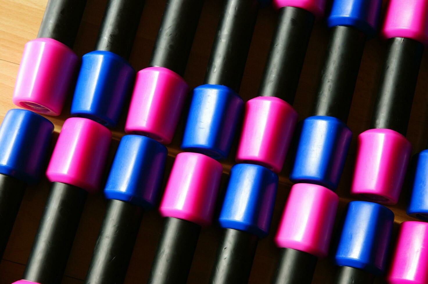 a pile of blue and pink plastic toys on a wooden floor photo