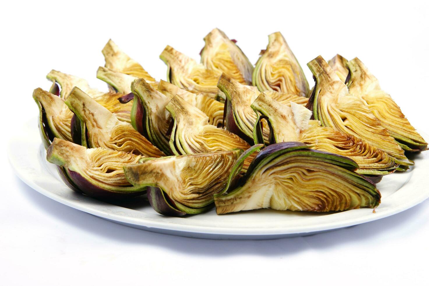 a white plate with four artichokes on it photo