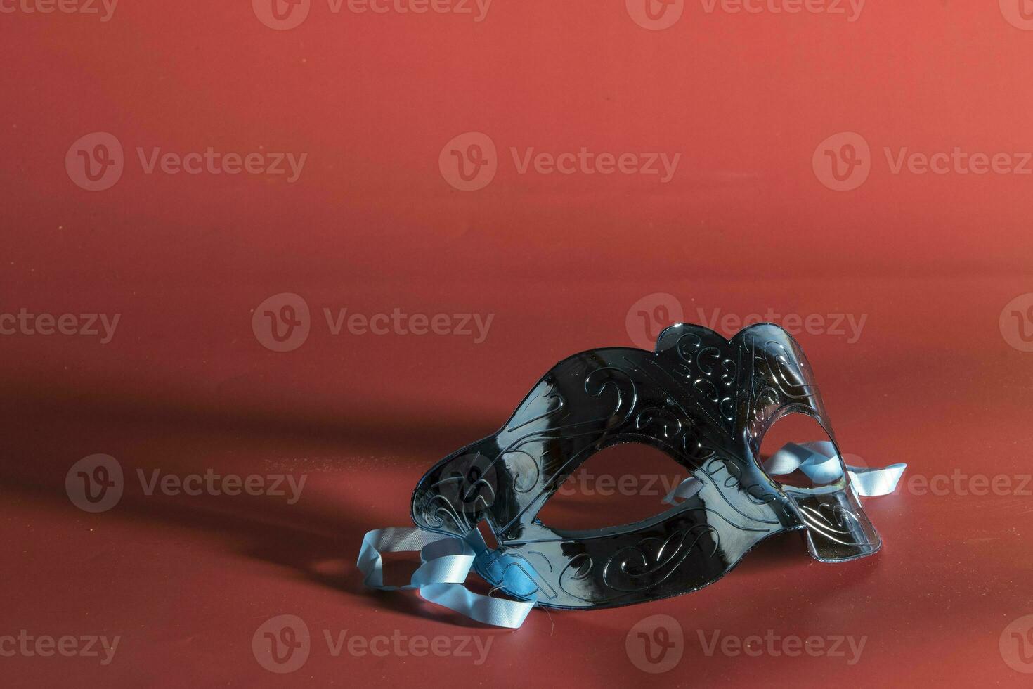 Venetian carnival mask, forming frame in one of the lower corners with space for text photo