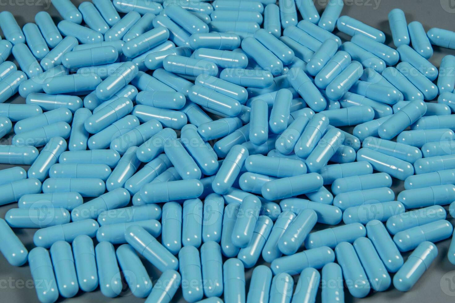 Blue antibiotic capsule pills texture. Pharmaceutical production. Global health. Resistance to antibiotic drugs photo