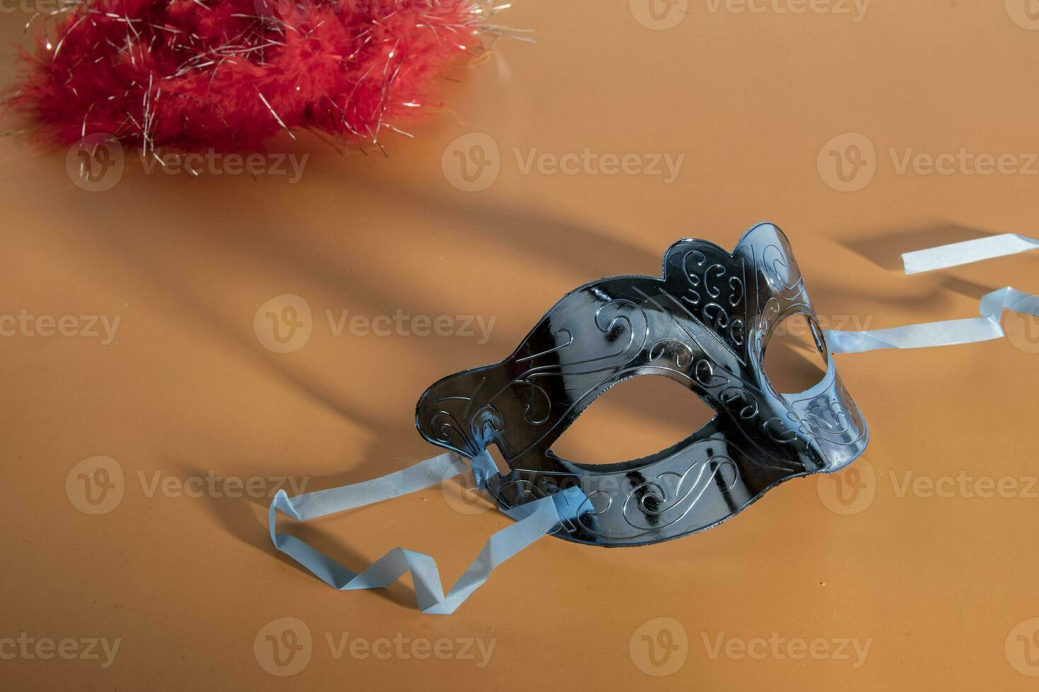 Venetian carnival mask, forming frame in one of the lower corners with space for text photo