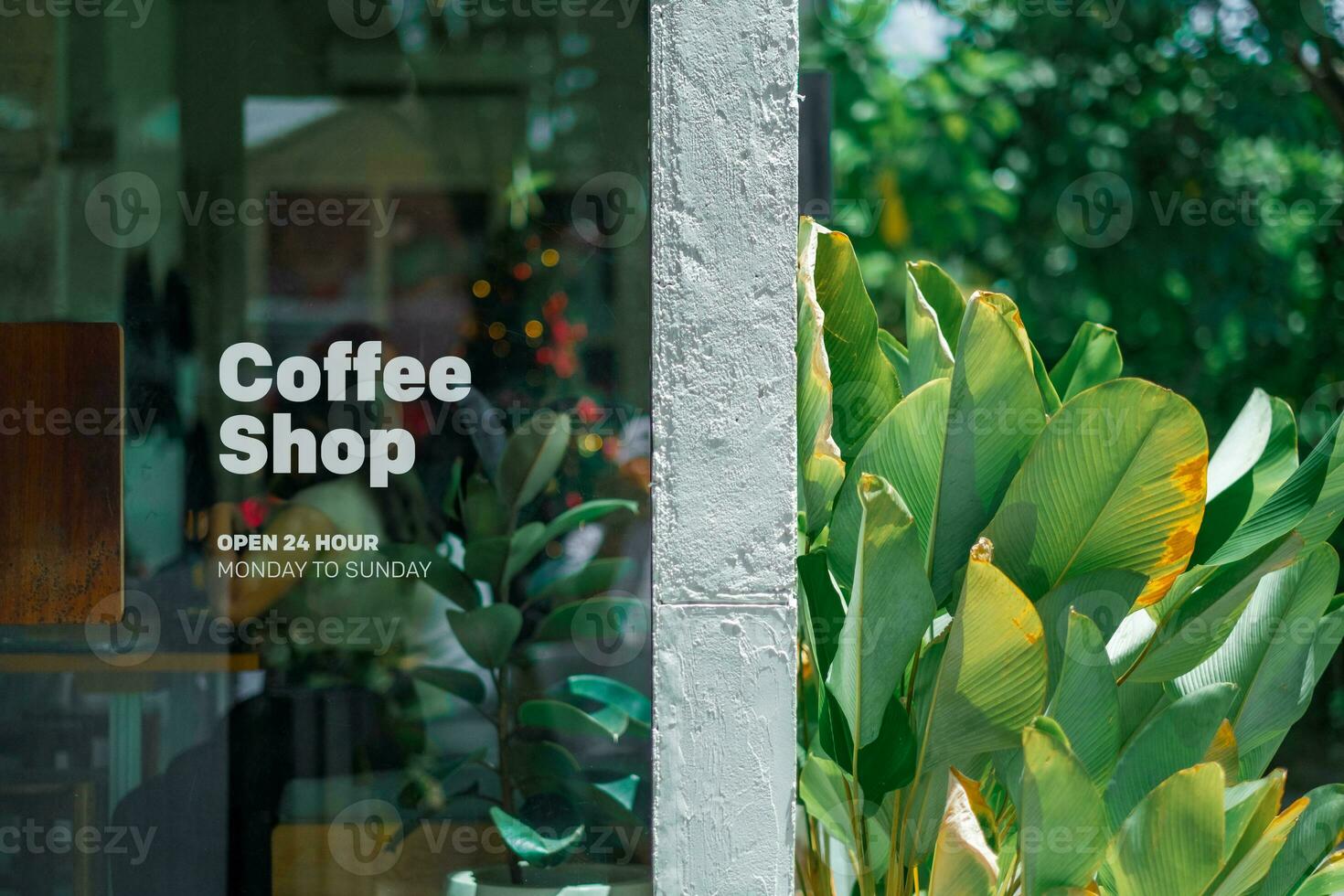 An exterior view of a coffee shop featuring a sign on the glass door photo