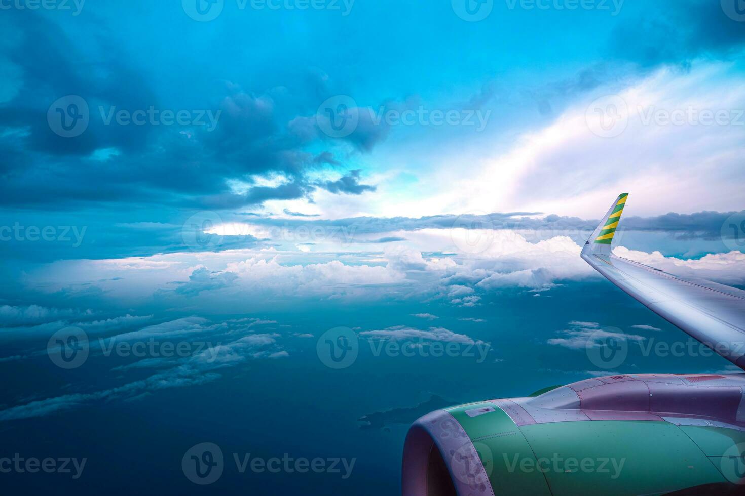 View from the airplane window on a beautiful sunset above the clouds. photo