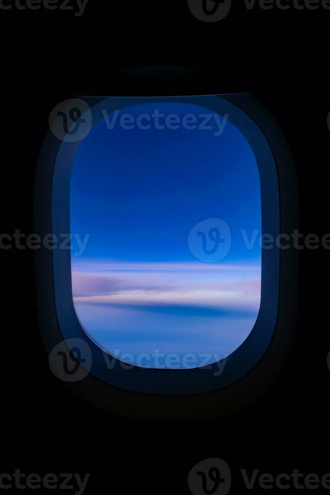 Blue sky view from airplane window with dark copy space for text photo