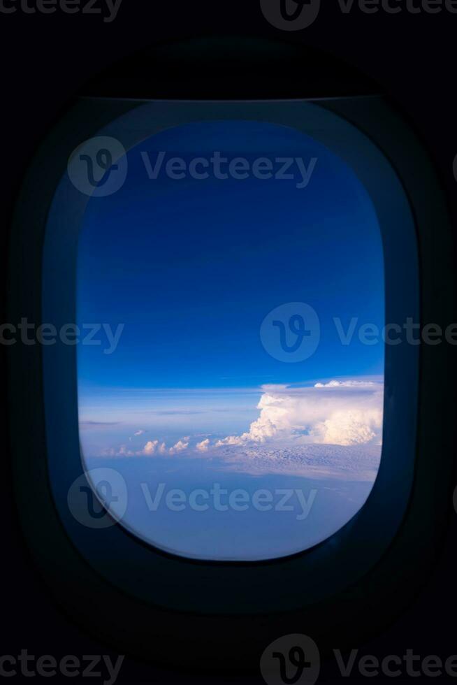 Blue sky view from airplane window with dark copy space for text photo