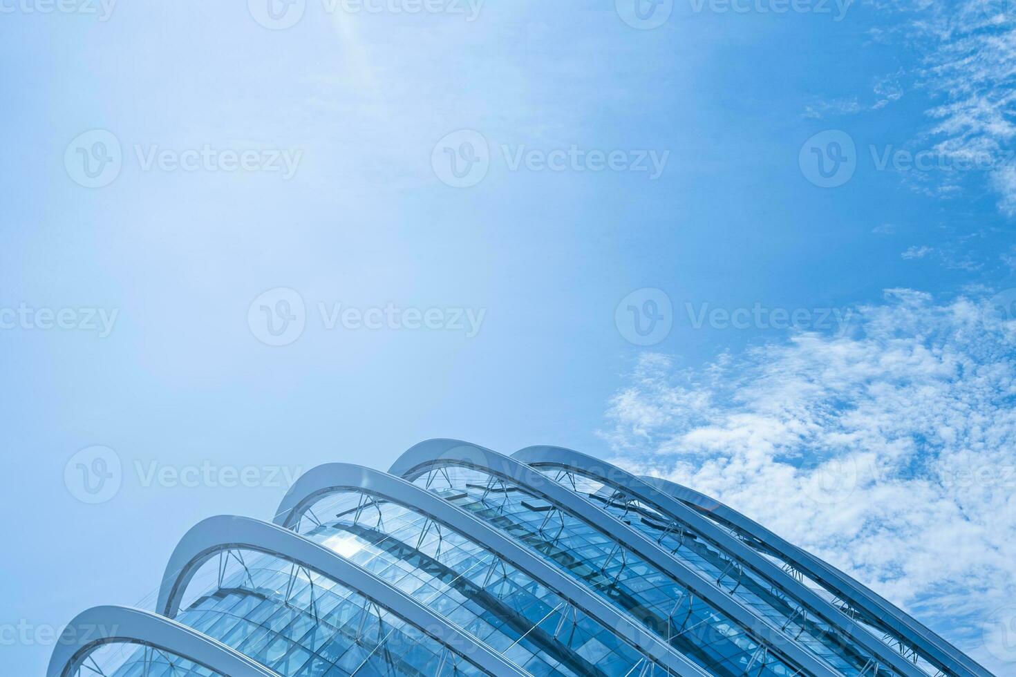 Curve Geometric steel metalic cladding on a generic modern building with blue sky photo