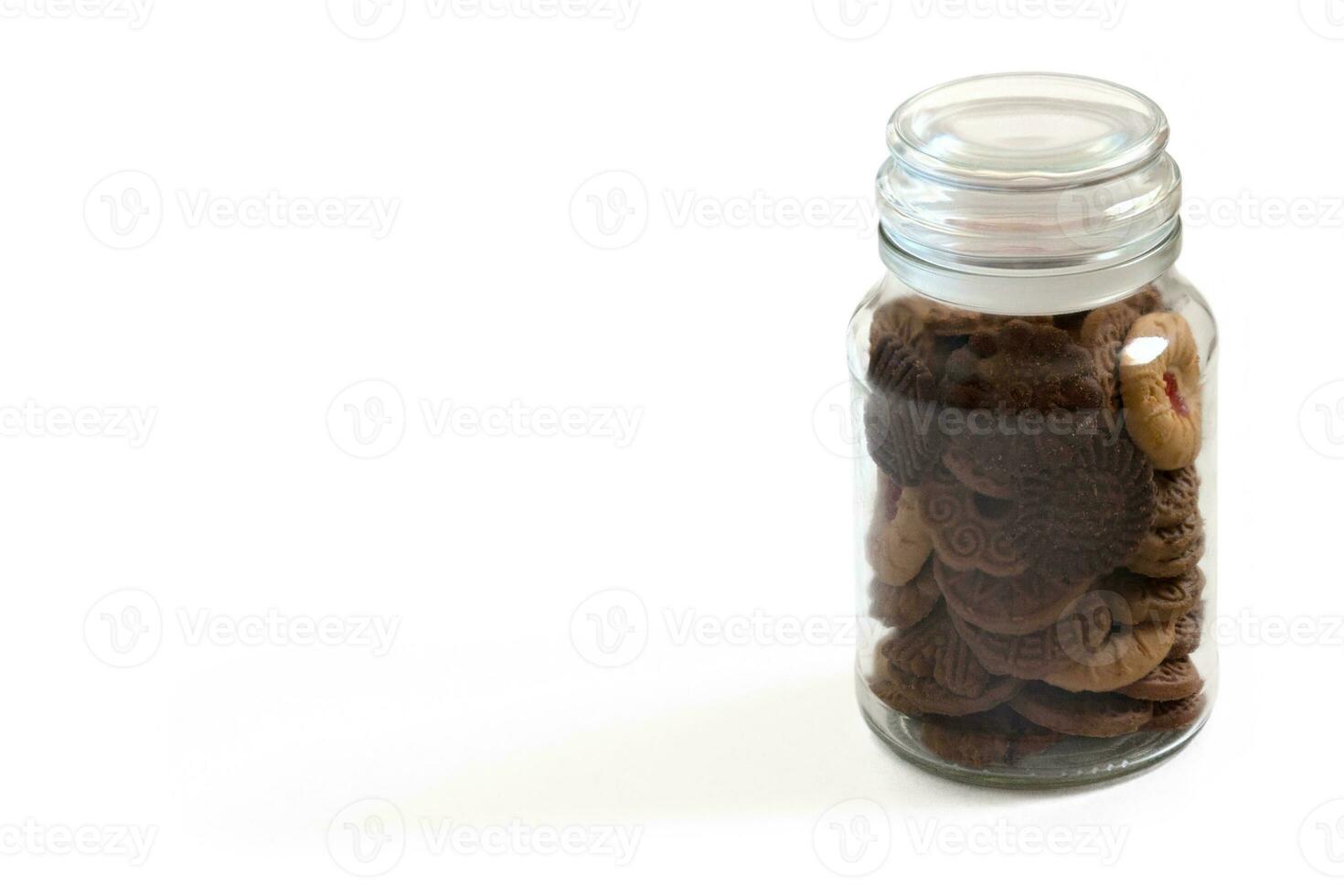 Jar of cookies on white background photo