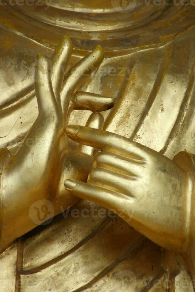 Close up on Buddha's praying hands photo