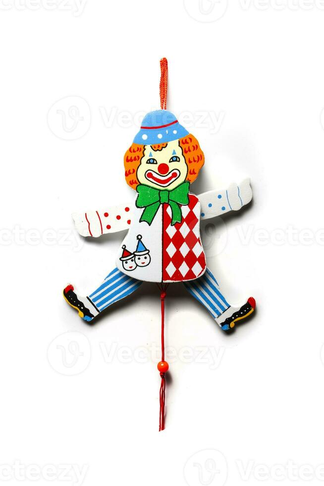 Clown toy isolated on white background. Funny clown on a string. The suspended clown.Baby rattle photo