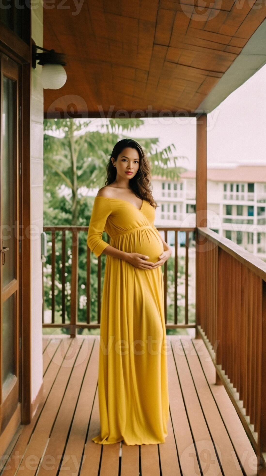 A beautiful pregnant woman in a blue dress hugs her pregnant