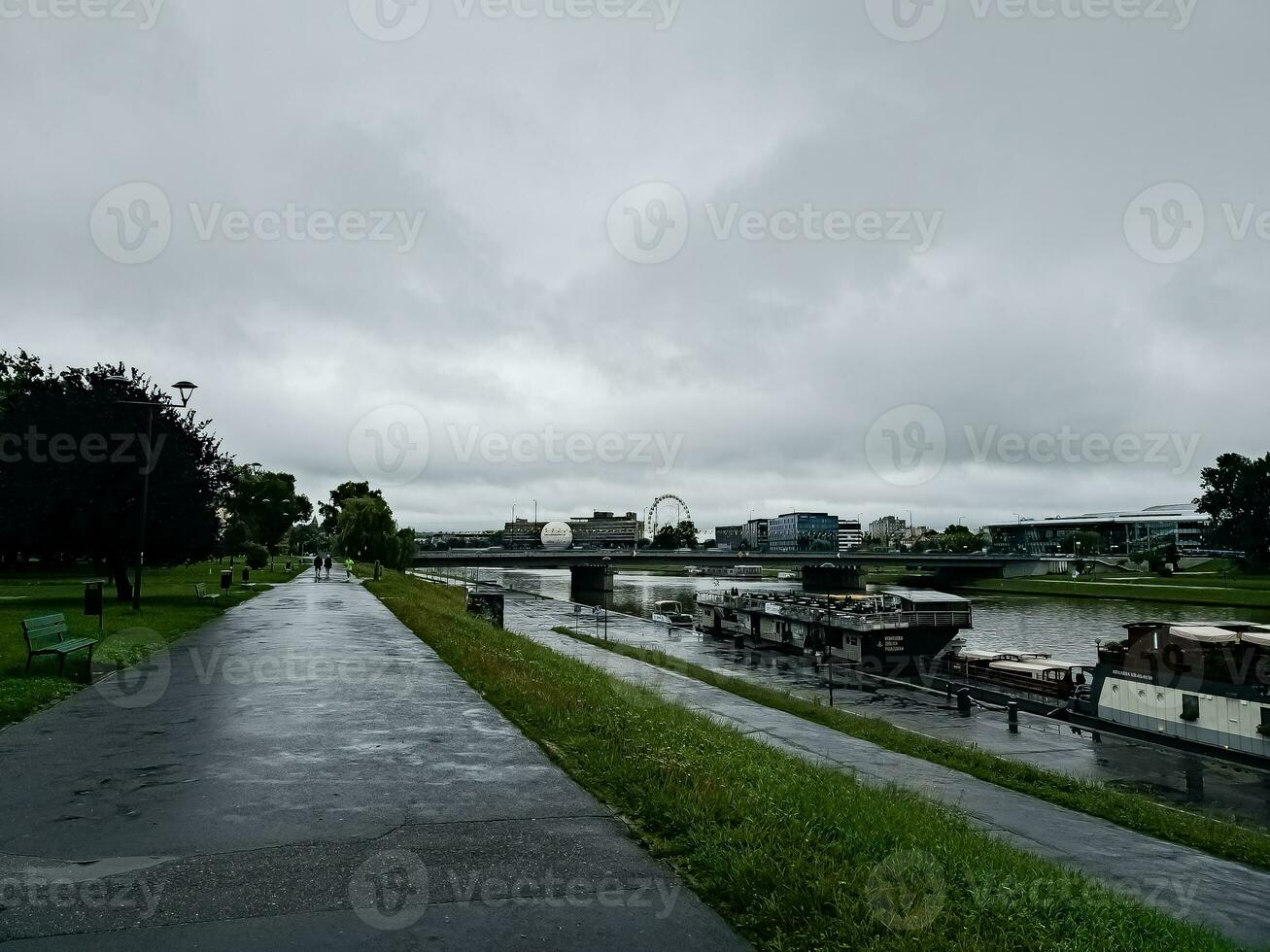 View of embankment with River Wisla in Krakow, Poland. Overcast weather. Cloudy. photo