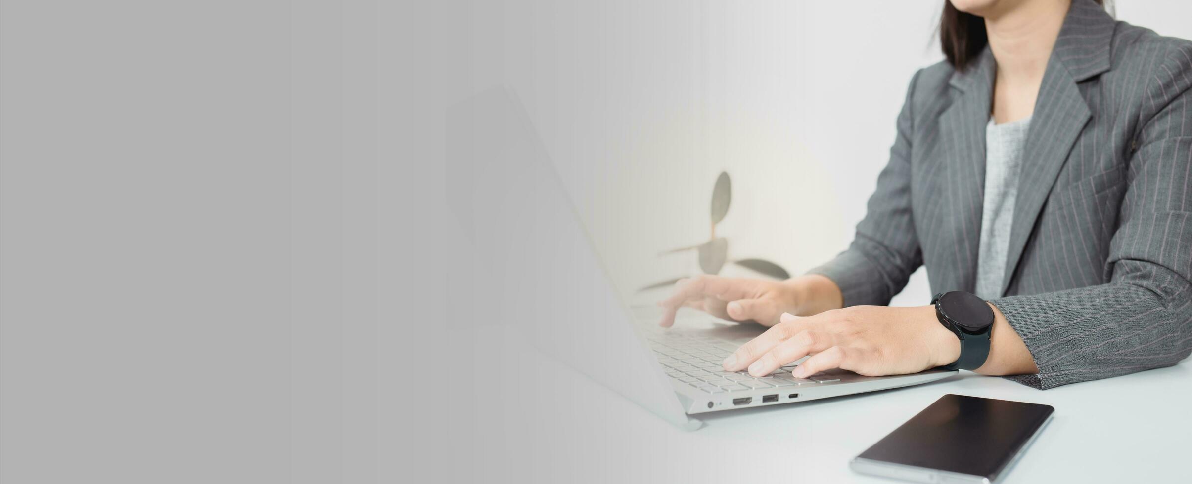 Attractive business woman Asian in suits  are smiling while working with computer at office. Customer service assistant working in office. panorama banner background photo