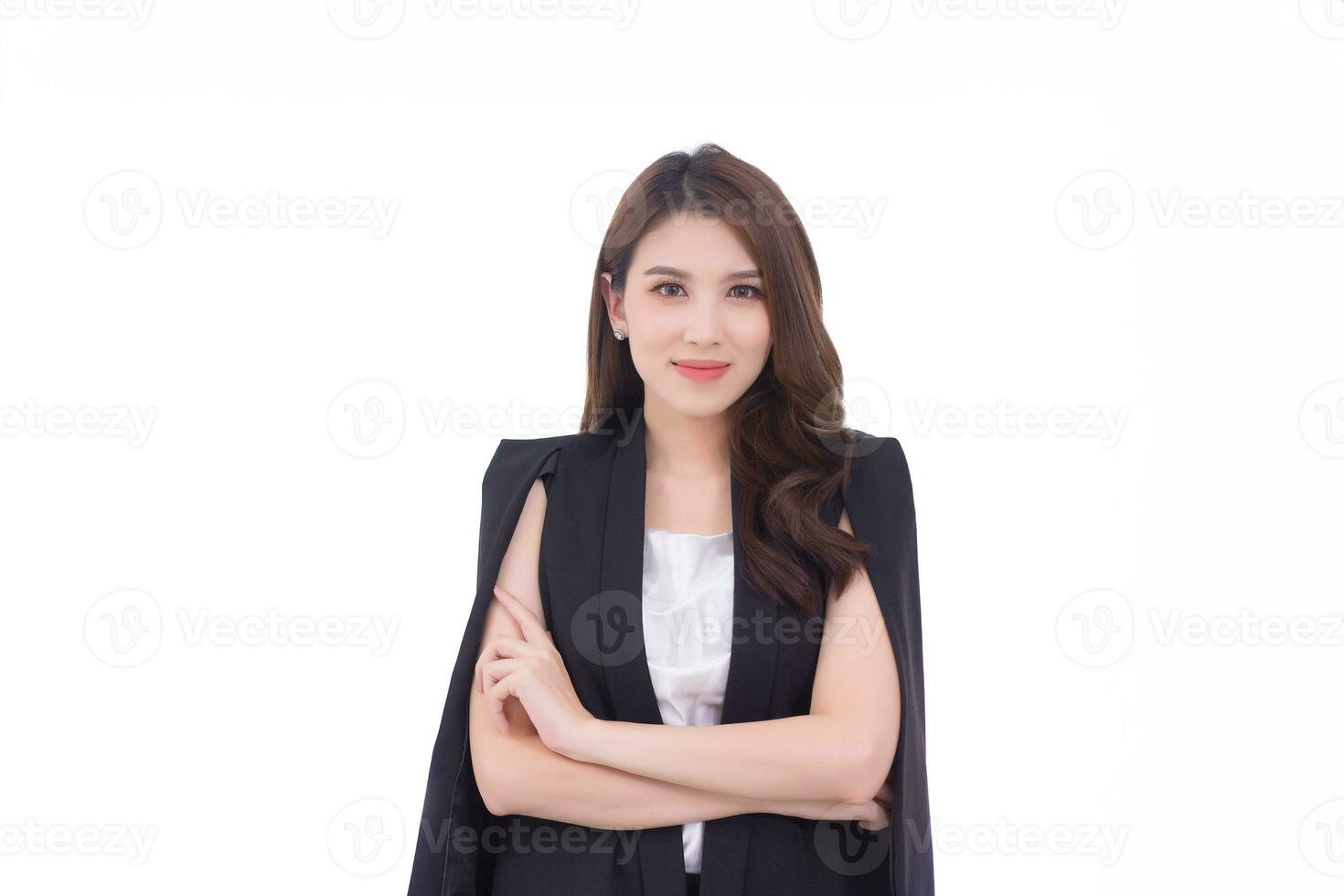 Professional young Asian confident working woman who has long hair with black suit is standing and arm crossing while working isolated on white background. photo
