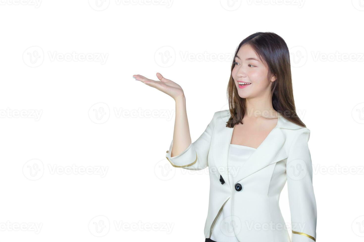 Professional young Asian female long brown hair in white suit is acting hand shows as presenting something and smiling working confidently and happily while isolated on white background. photo