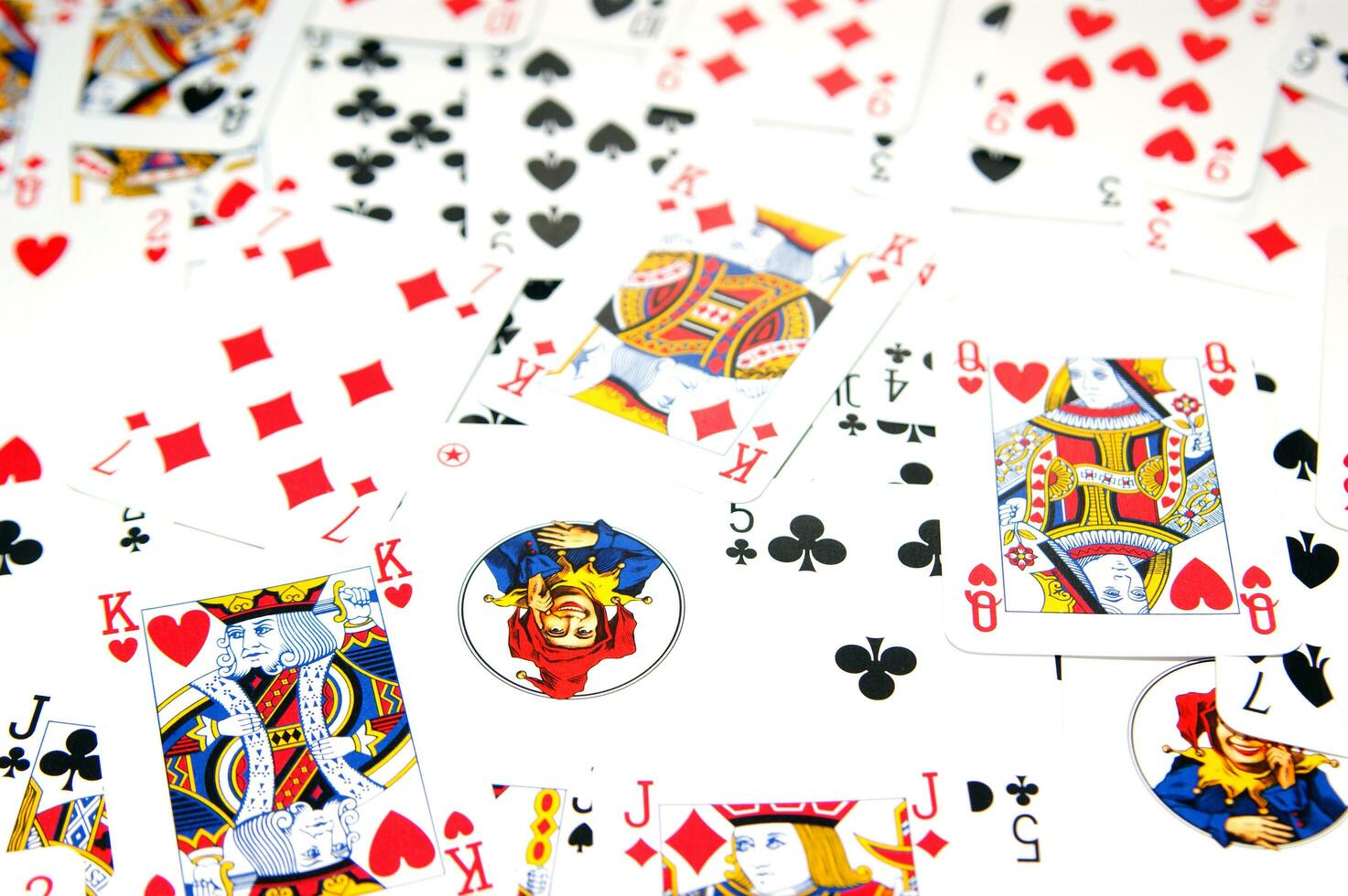 a pile of playing cards on a table photo