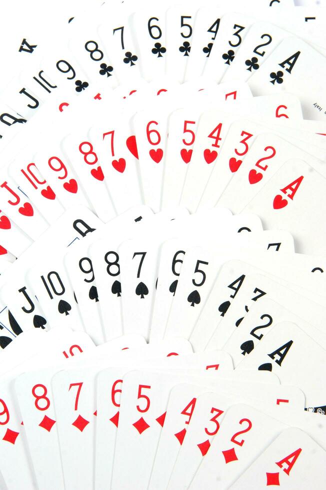 a pile of playing cards on a table photo