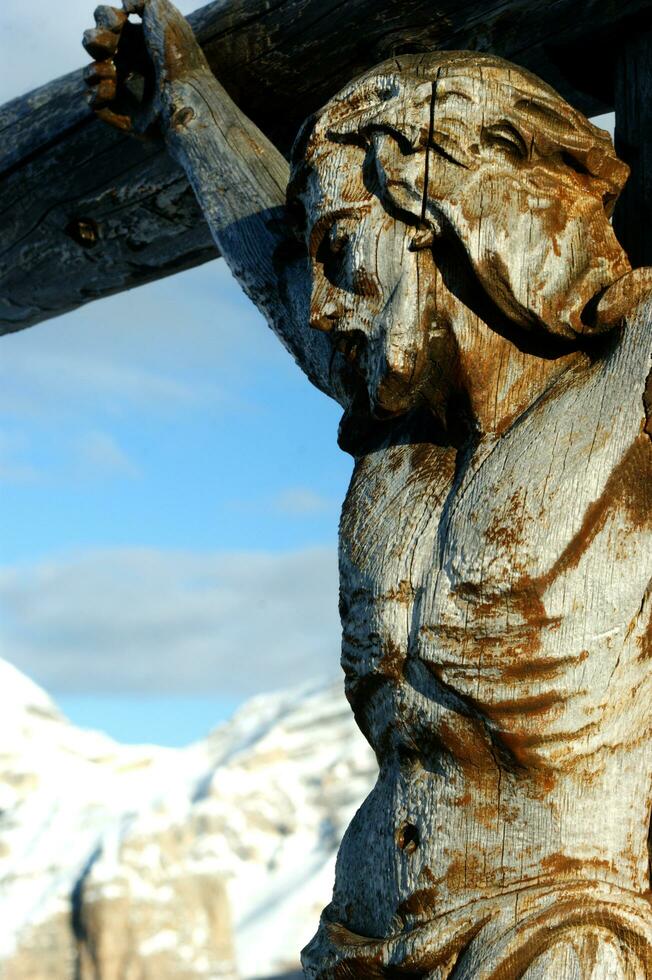 a wooden statue of jesus on the cross photo