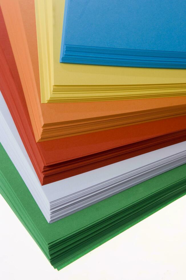 a stack of colored paper with a white background photo