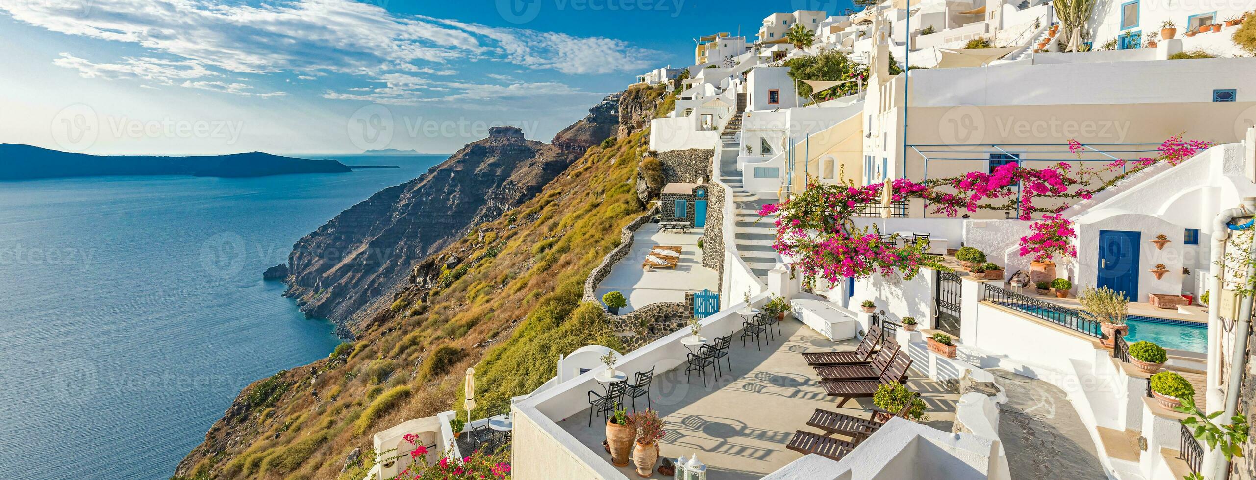 Amazing evening view of Santorini island. Panorama of summer sunset on the famous Greek resort Fira, Greece, Europe. Luxury travel concept background. Summer vacation or holiday, fantastic scene photo