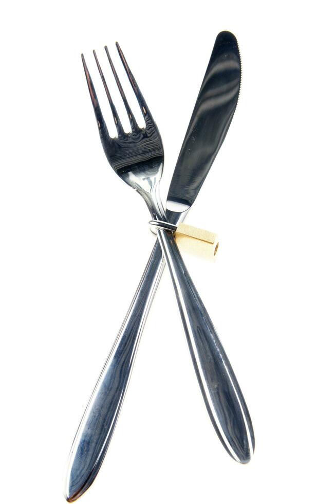 a fork, knife and spoon are arranged in a holder photo