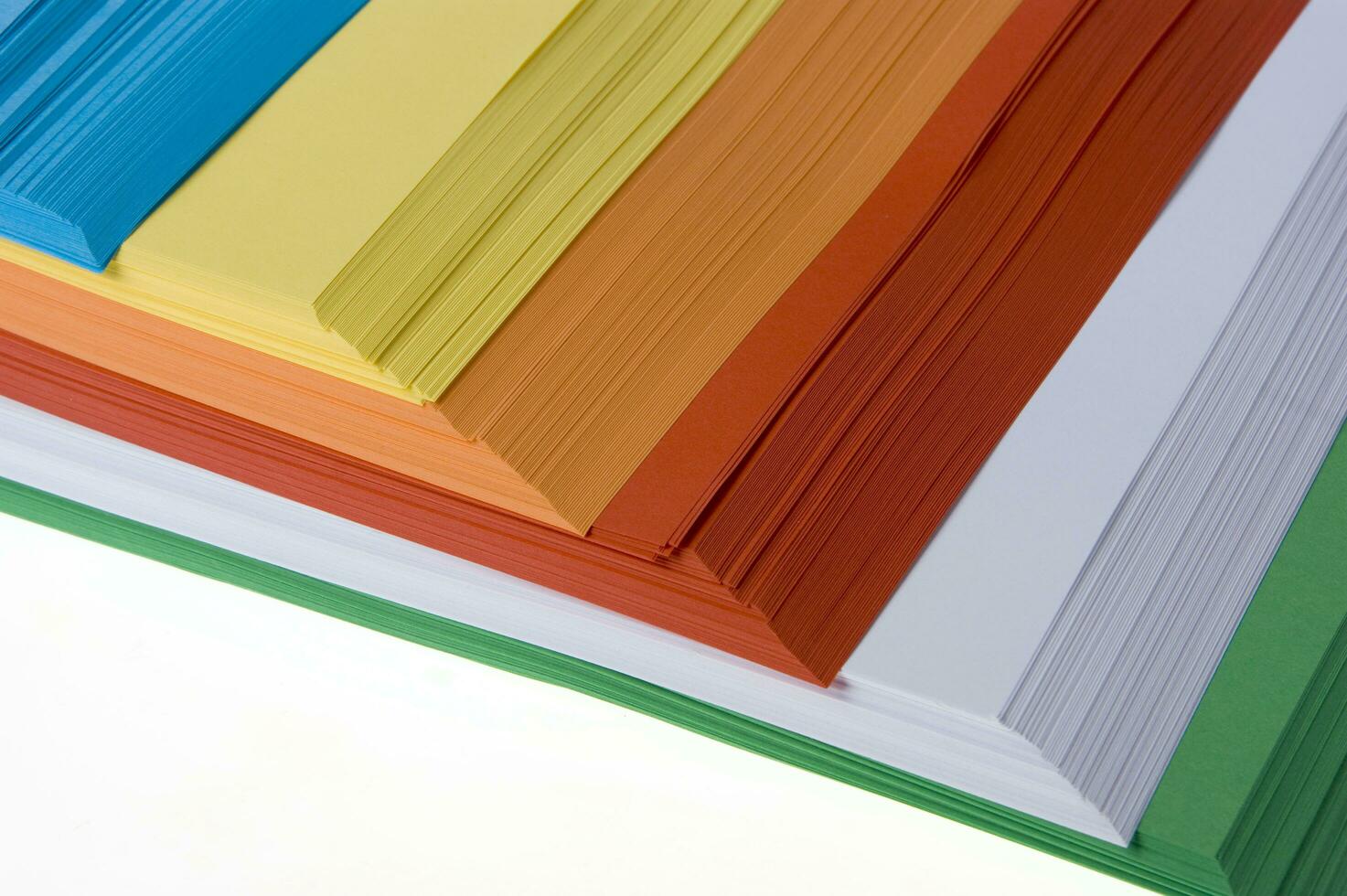 a stack of colored paper with a white background photo