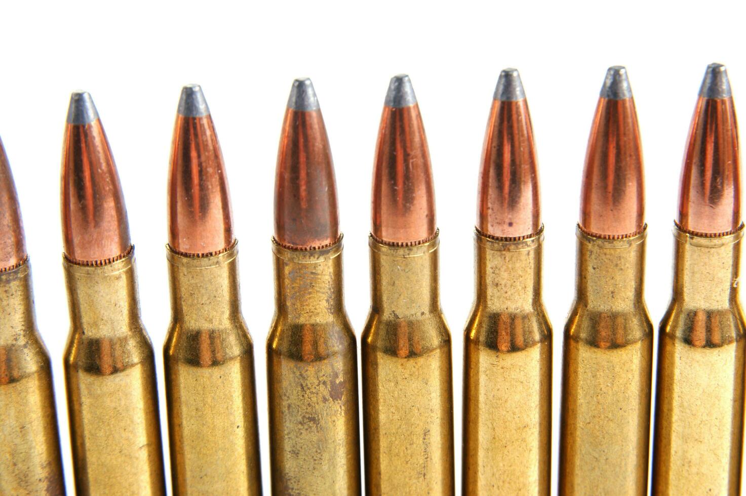 a row of bullet cartridges on a white background photo
