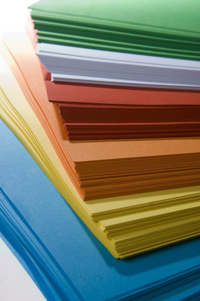 a stack of colored paper with a white background photo