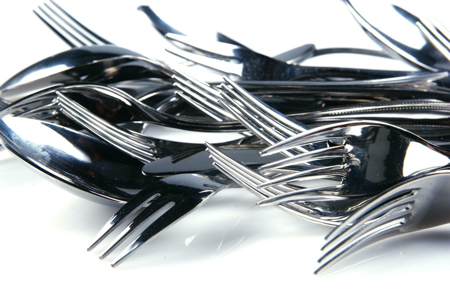 a bunch of silver forks and knives photo