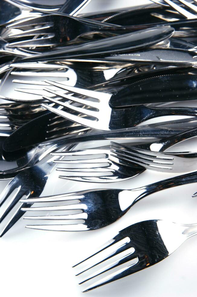 a bunch of silver forks and knives photo
