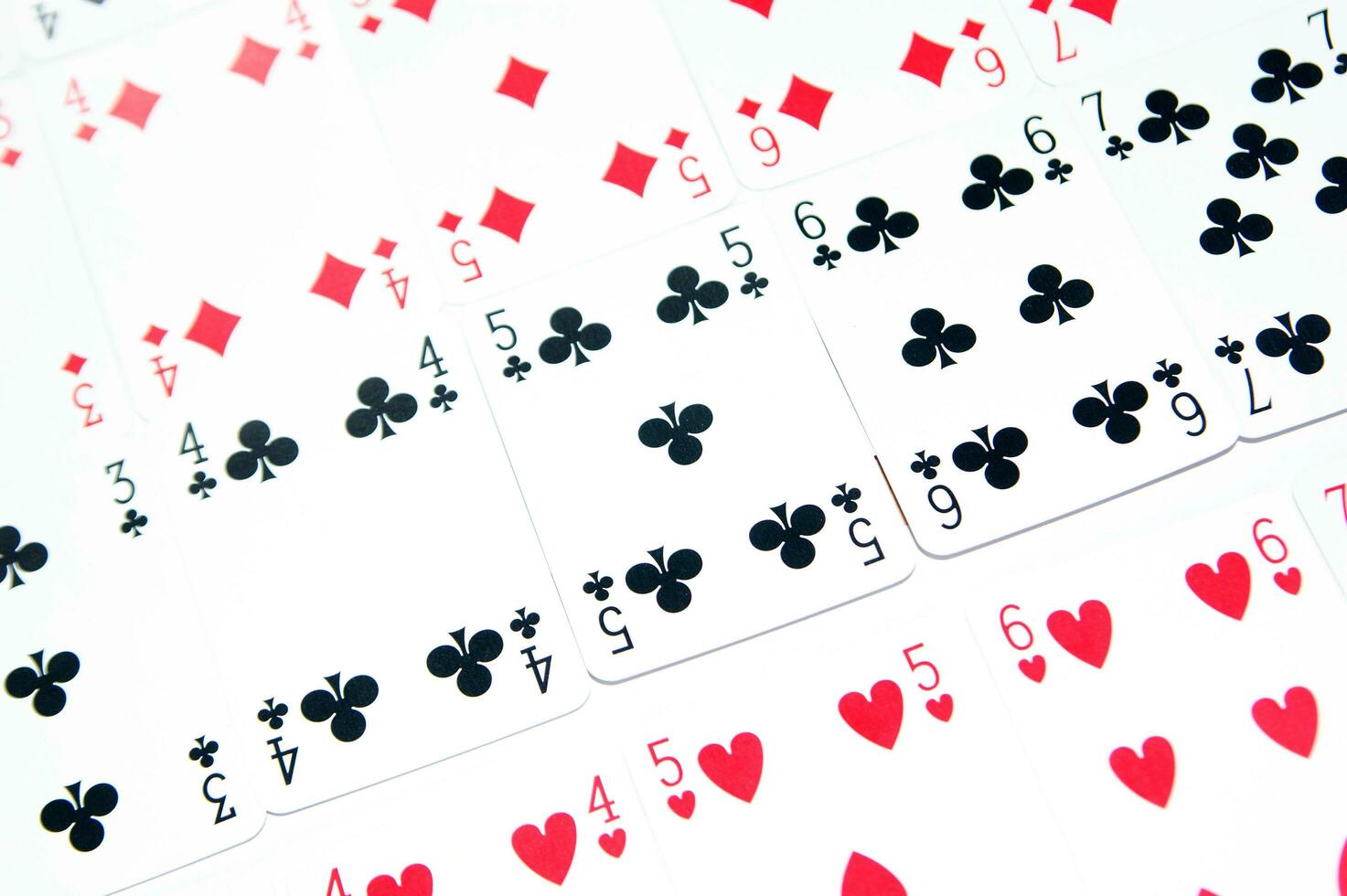 a pile of playing cards on a table photo