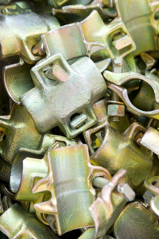 a pile of metal clips and nuts in a pile photo