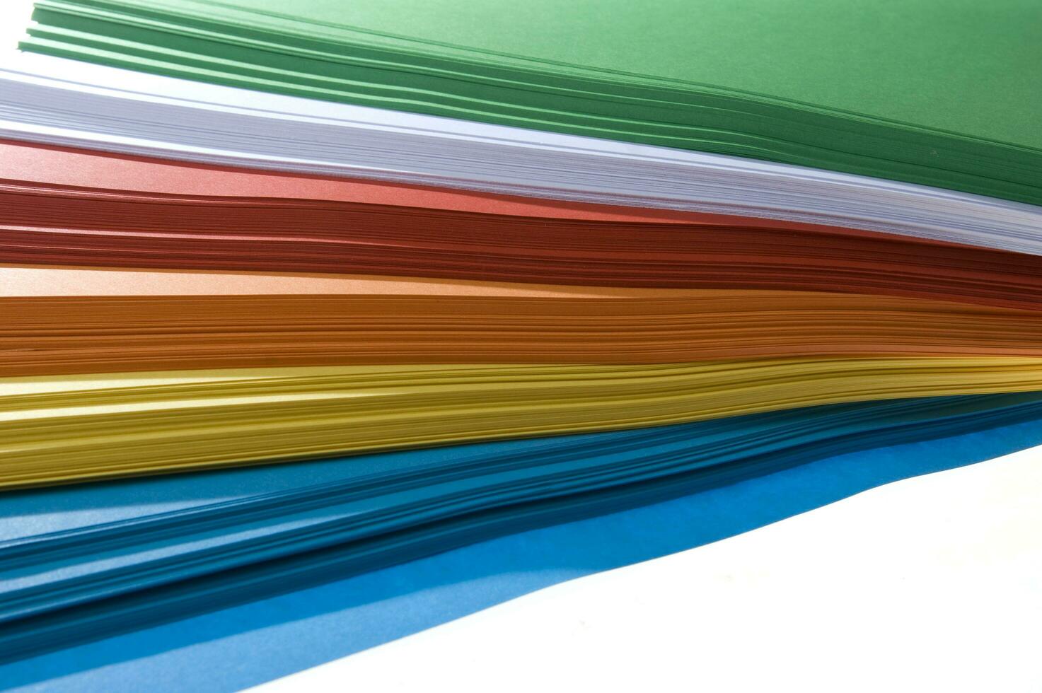 a stack of colored paper with a white background photo