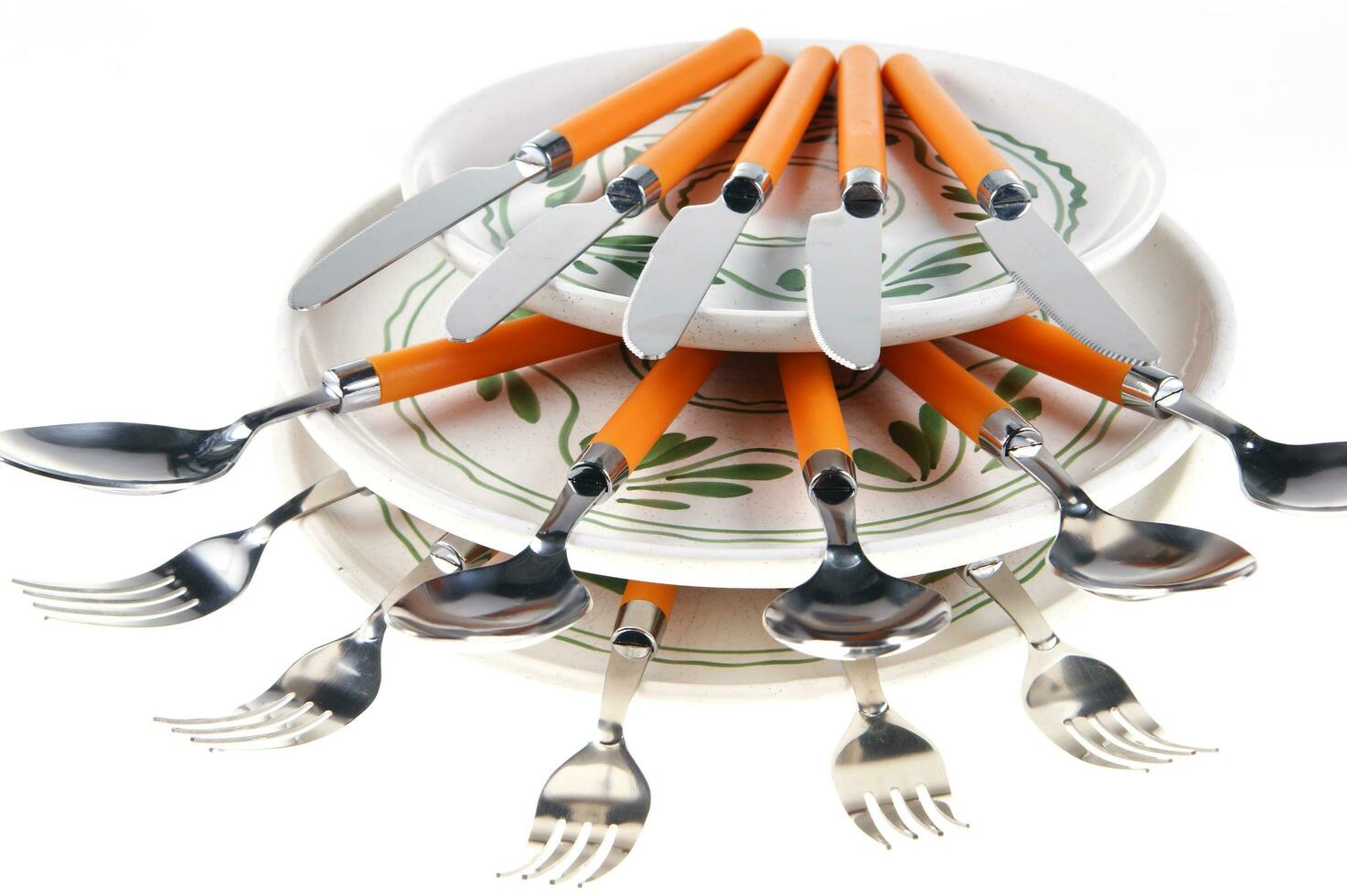 a stack of plates with spoons on top photo