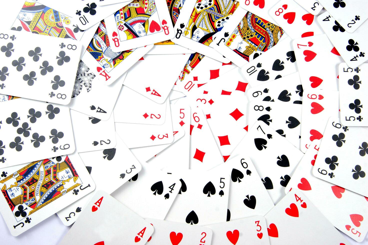 a pile of playing cards on a table photo