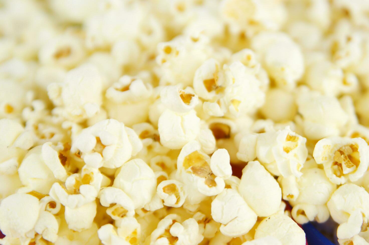 four colorful bowls of popcorn on a white surface photo