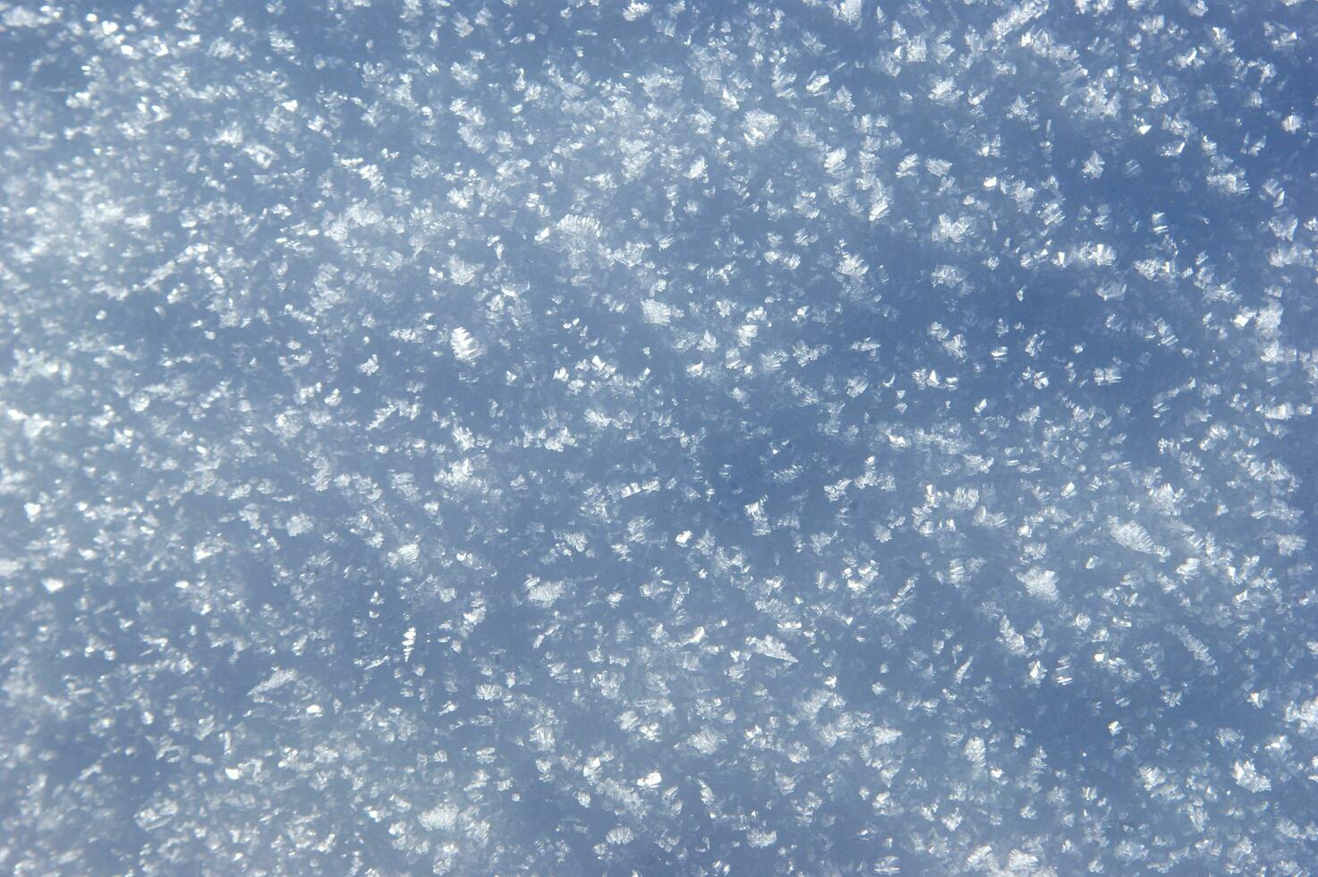 a close up of snow falling from the sky photo