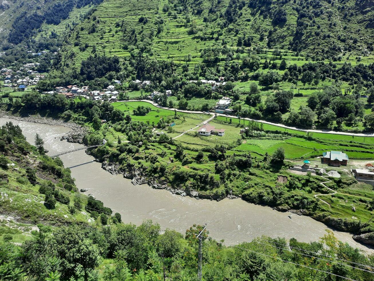 Beautiful day time view of Keran Valley, Neelam Valley, Kashmir. Green valleys, high mountains and trees are visible. photo