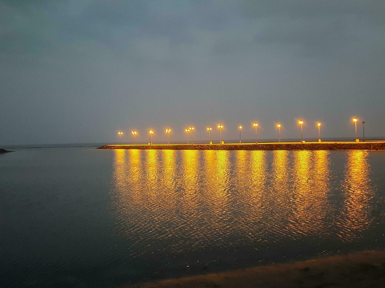 Beautiful morning view of Al Qunfudhah Beach, Saudi Arabia. The lights on the beach are creating a beautiful scene in the morning. photo