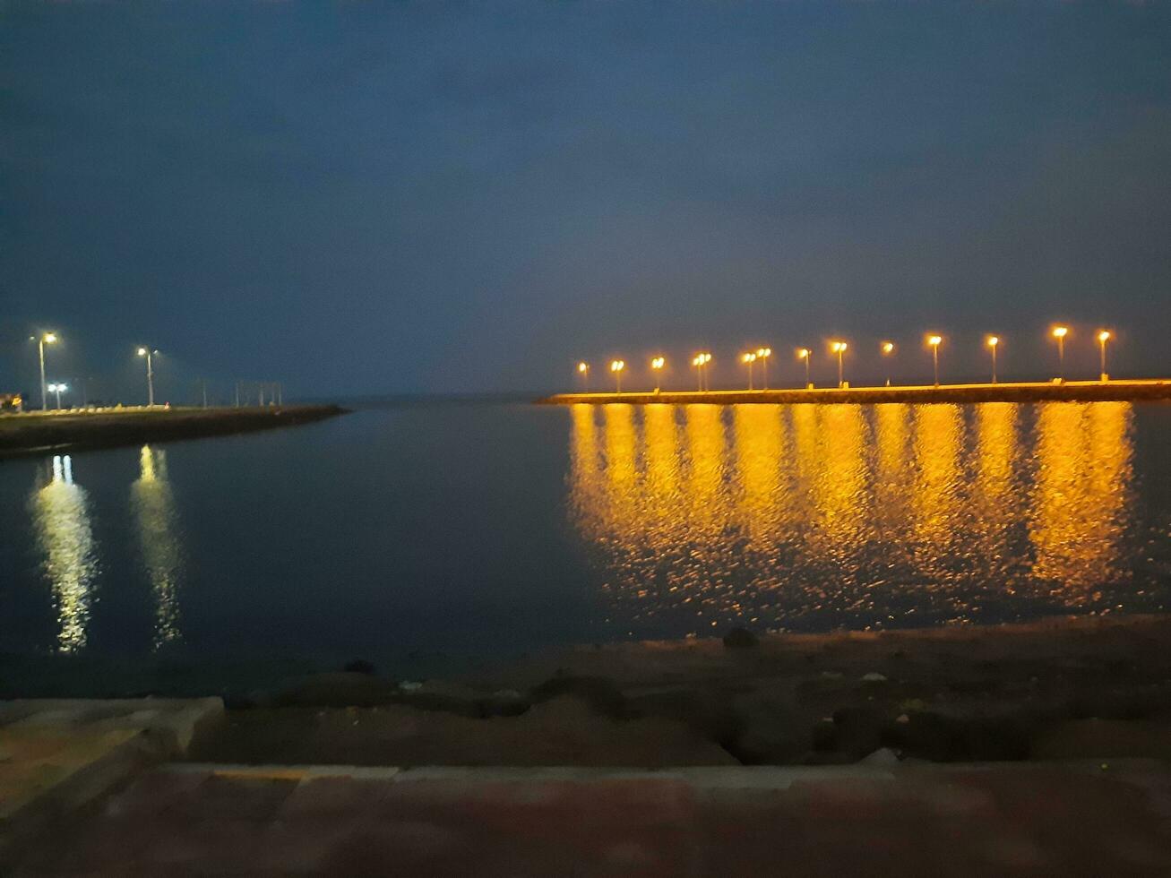 Beautiful morning view of Al Qunfudhah Beach, Saudi Arabia. The lights on the beach are creating a beautiful scene in the morning. photo