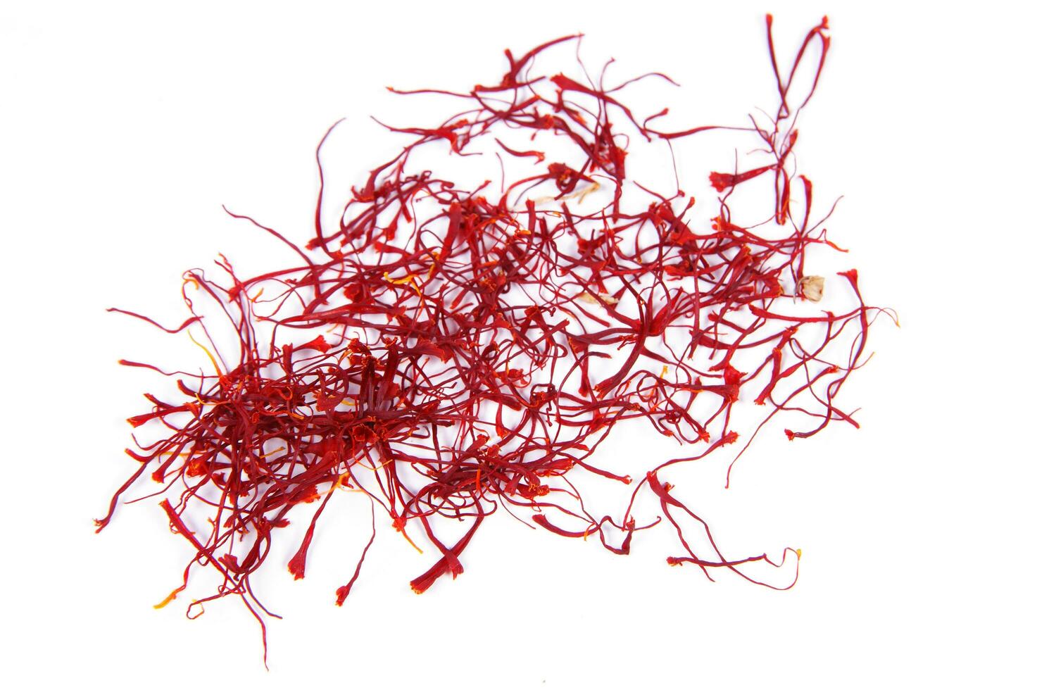a pile of red saffron on a white background photo