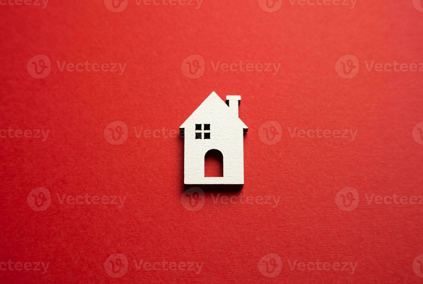House on a red background. Buying and selling housing. Real estate market review. Construction industry. Property insurance. Design and architectural services. photo