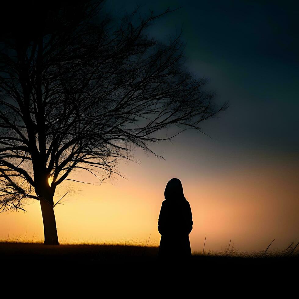 Silhouette of a lonely woman stands alone photo